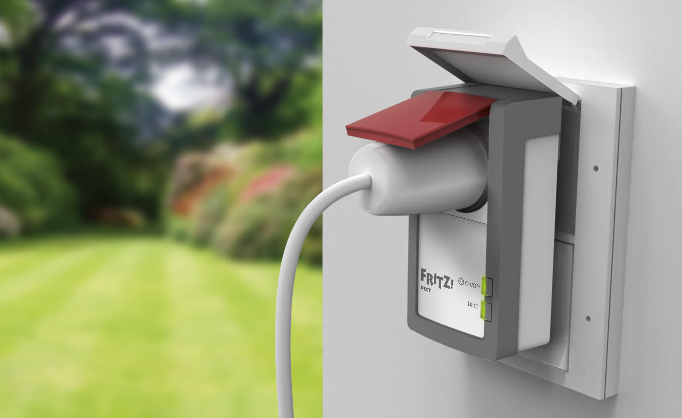 This picture shows the outdoor power outlet FRITZ!Dect 210 in oblique side view in a garden and with an additional plug.